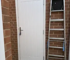 GRP composite door, opening out in white installed to a garage in Derby
