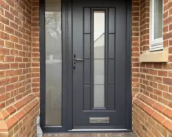Rockdoor Vermont in Anthracite Grey, matching external frame, Continuity glass and large sidepanel with Satin Glass, fitted in Derby