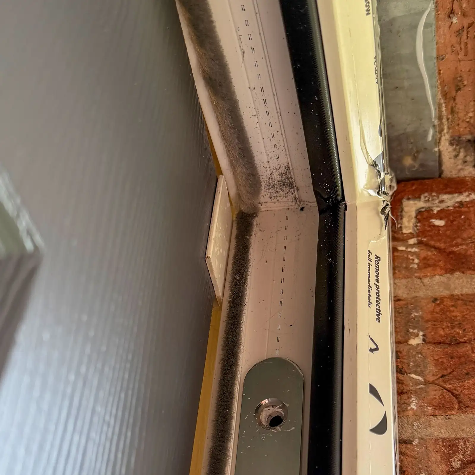 Checking the twist at the top of the Rockdoor during installation by very secure doors