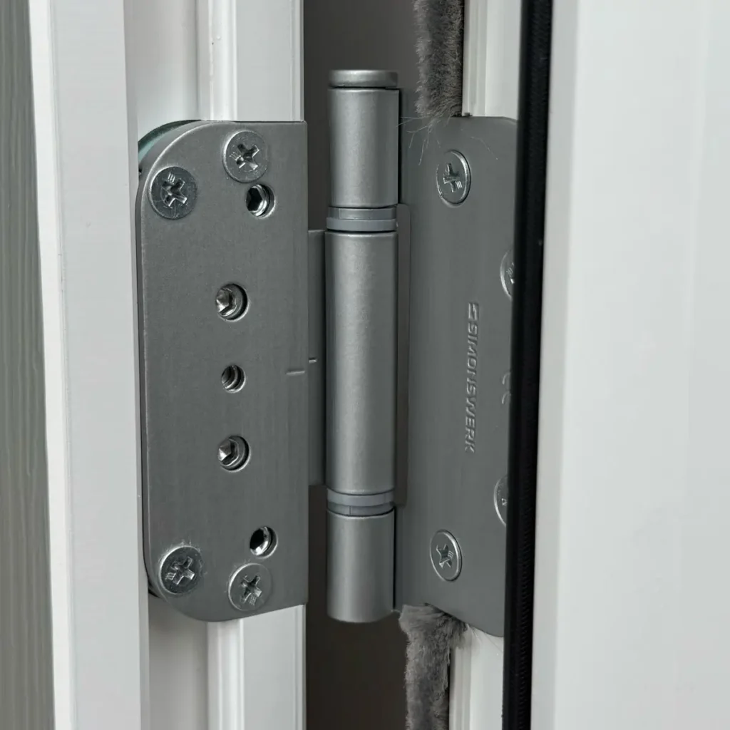 Close up of a Rockdoor 3D hinge in Satin Silver