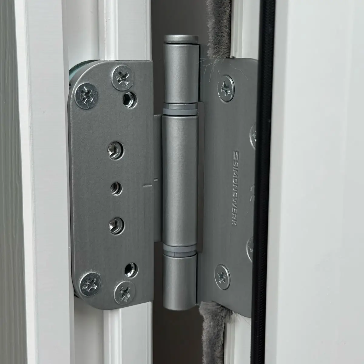 Close up of a Rockdoor 3D hinge in Satin Silver