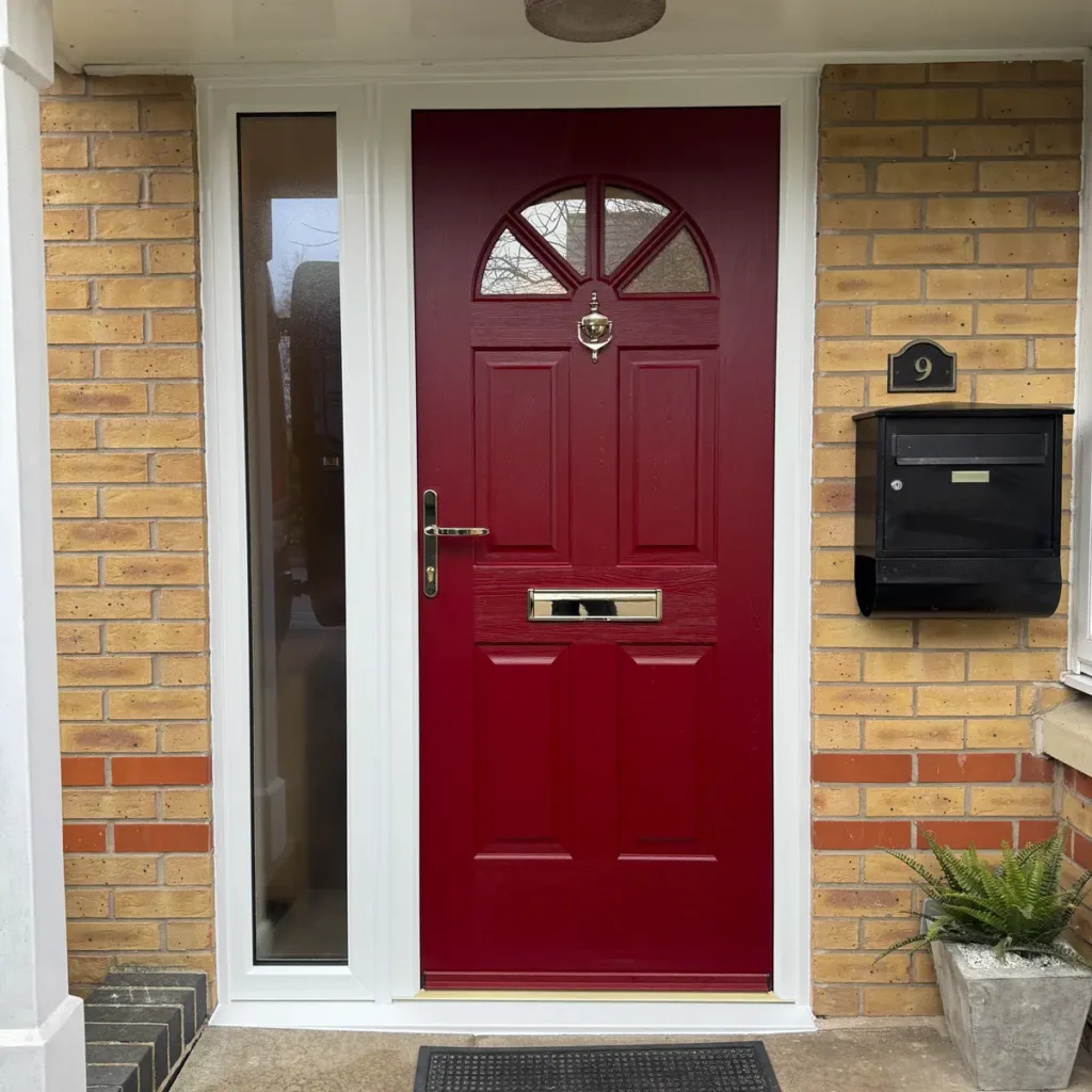 Composite front door in Red with gold furniture and side panel with Satin Glass fitted in East Leake, Leicestershire