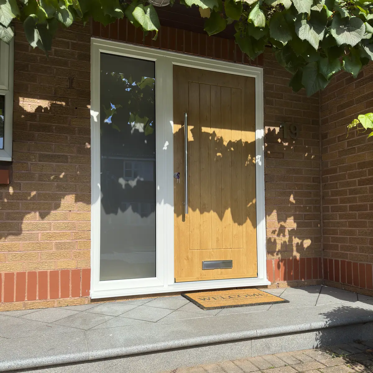 Composite door and side panel in Irish Oak with long bar handle fitted in West Bridgford, Nottingham