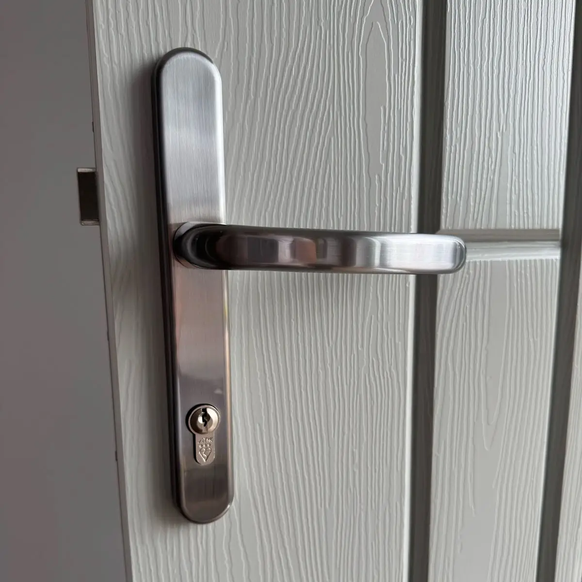 Close up of a Rockdoor Lever handle in satin chrome externally