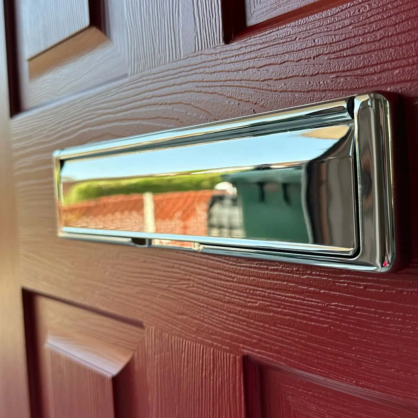 Close up of a Rockdoor letterplate externally in Polished Chrome
